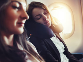 friends traveling by air sleeping on plane