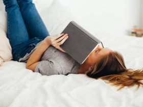 relaxed woman on bed with book