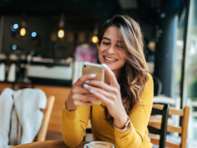 happy woman looking at smartphone
