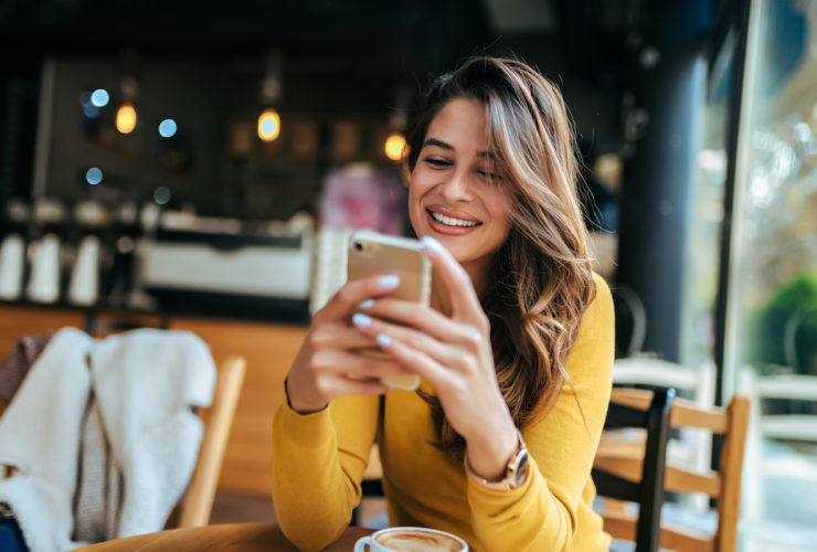 happy woman looking at smartphone