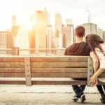 man and woman snuggling on a bench