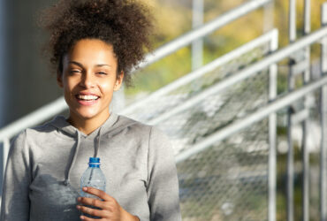 happy smiling young bipoc woman continuing to pursue her goals and not give up