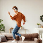 moving meditation. Happy young woman dances in her living room.