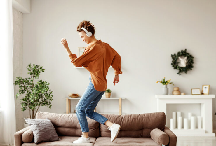 moving meditation. Happy young woman dances in her living room.