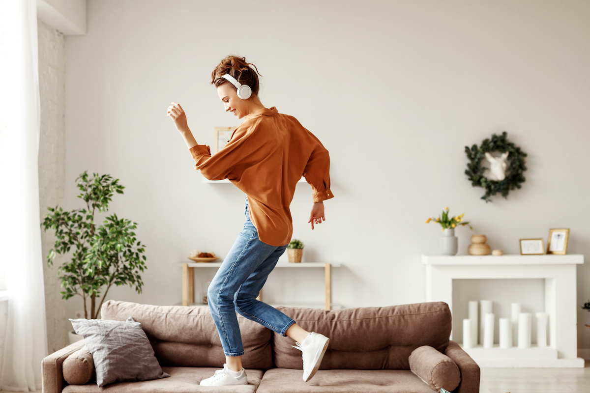 moving meditation. Happy young woman dances in her living room.