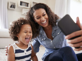 mother and daughter having fun on phone