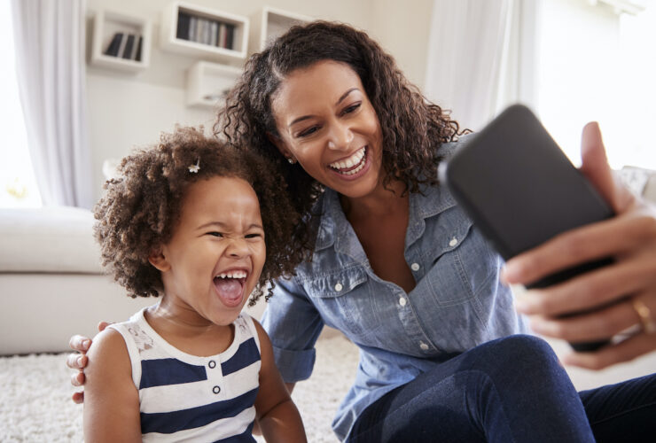 mother and daughter having fun on phone