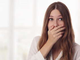 Embarresed woman holding mouth leaky bladder