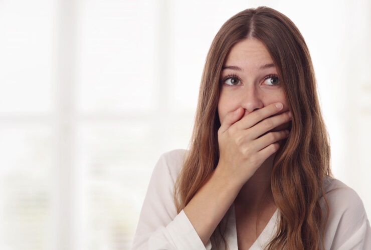 Embarresed woman holding mouth leaky bladder
