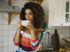 Beautiful young woman enjoying a cup of energizing caffeine free tea