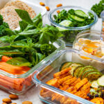 Glass meal-prep containers full of food. Find out how to start meal prepping at home.