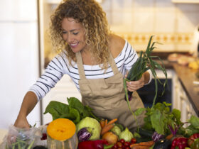 Smiling woman in the kitchen prepping food for Instant Pot recipes.
