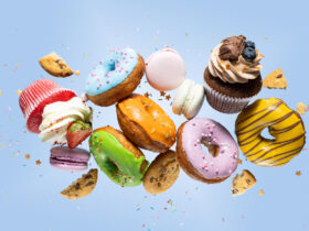 Variety of sweet treats donuts and cookies against a blue background