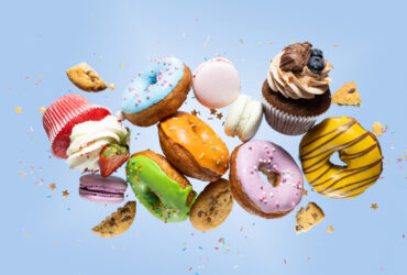 Variety of sweet treats donuts and cookies against a blue background